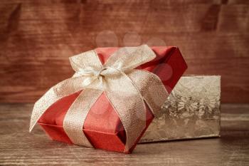 Present box on wooden background, holidays concept.