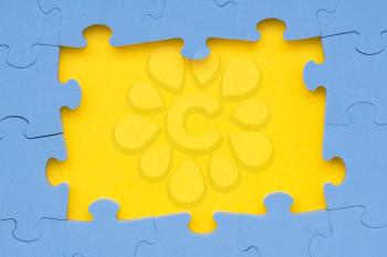 The frame from blue puzzle on yellow background for your text