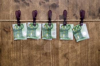  Euro banknotes hanging on a rope with clothes pins.Money laundering concept