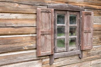 Wooden log house,window with open shutters