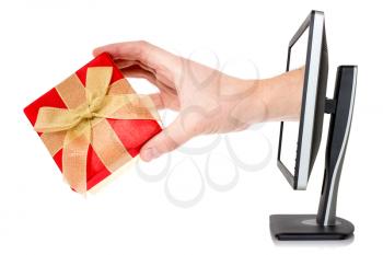 Hand with gift box comes out of monitor.Isolated on white background.