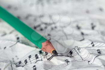 Music notes and pencil, shallow DOF
