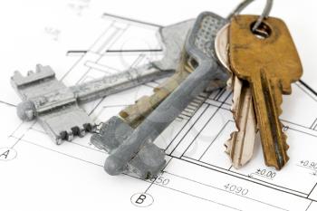 Close-up photo of keys on architectural blueprint
