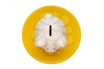  Savings consumer concept. Piggy bank on the yellow plate isolated on white background.