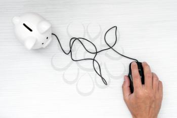 Computer mouse connected to piggy-bank. E-commerce, saving, online shopping and business marketing technology concept.