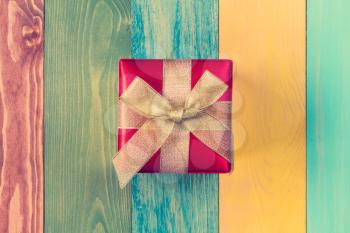 Gift box on color wooden background.Top-view.