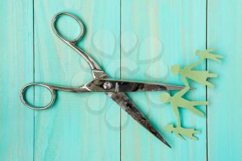 Scissors cutting paper cut of family. Divorce concept