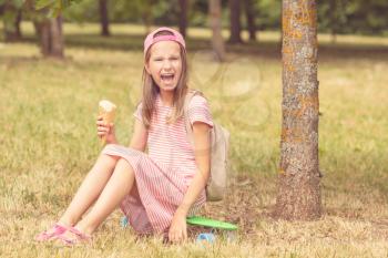 Child girl laughing and holding ice cream