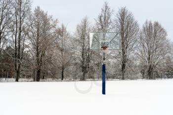 Basketball court in the winter under the snow