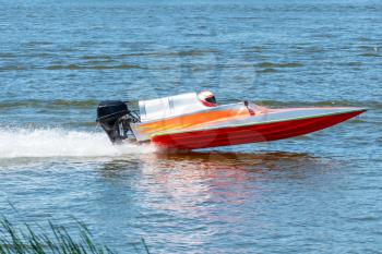 Speed boat go fast along the lake in powerboat competition