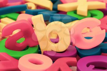 Letters ABC on the pile of colorful plastic letters and numbers.Learning or education concept