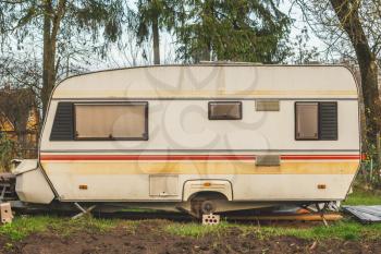 Abandoned vintage caravan/ camper Van parked at the garden