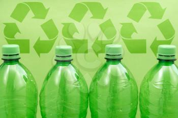 Recycle concept, plastic bottles with green recycle signs