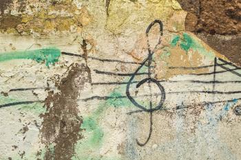 Treble Clef painted on the old concrete wall 