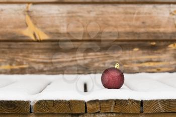 Christmas bauble in the snow. Christmas and New Year background.