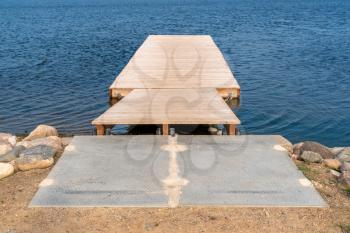 Perspective view of a wooden pier over a wavy surface of water