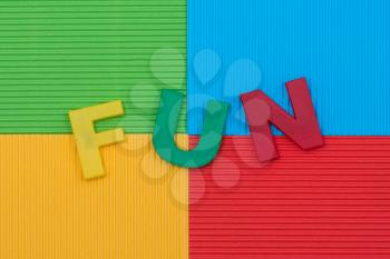 Word FUN with colourful letters on the color paper background