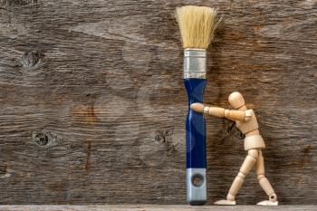 Dummy holding painting brush. The concept of repair, change, design, interior. DIY Home Projects & Repairs To Do While Quarantined at Home.