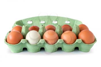 Egg carton with brown eggs and a single white egg. Don't be afraid to be different concept
