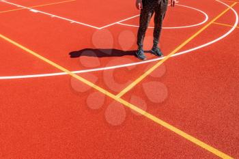 Man standing in the newly made outdoor basketball court