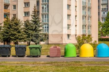 The different garbage bins in residential area. Separate garbage collection problem, household waste recycling.