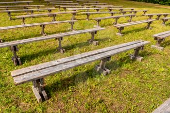 Empty wooden outdoor benches for spectators in the open air
