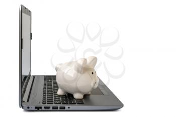 Piggy bank with laptop which means make money online or internet business concepts. Isolated on white background.
