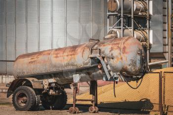 Old tanker for manure or sewage in the farm yard.  Manure is used as fertilizer in agriculture. 