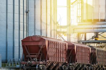 A series of grain cars being loaded with grain at a grain elevator 