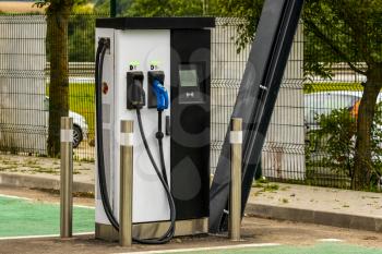 Modern electric car charging station at parking