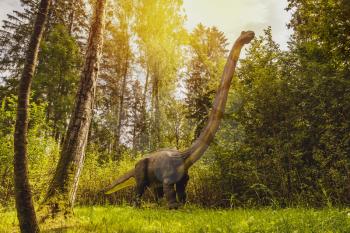Big model of prehistoric dinosaur in the nature. Realistic scenery.