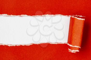 Red paper torn to reveal white copy-space ideal for your text