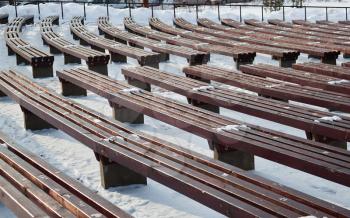 Benches in empty concert under the winter sky