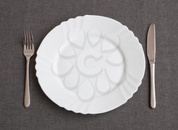 Set of utensil for dinner: plate, fork and knife