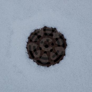 Hatch sewer in  the snow