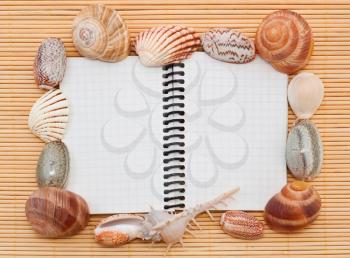 Sea tematic spiral notebook on wooden background