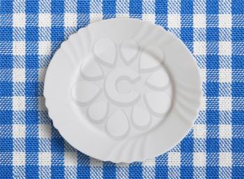 Lined white and blue dining cloth with plate