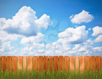 Fence with grass over the blue sky