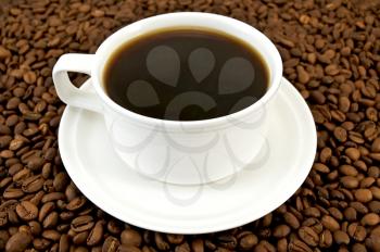 Royalty Free Photo of Cup of Coffee on Beans