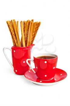 Bread sticks and coffee in the red utensil isolated on a white background