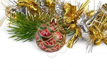 Christmas red ball ornament, a branch of pine, gold and silver tinsel isolated on white background