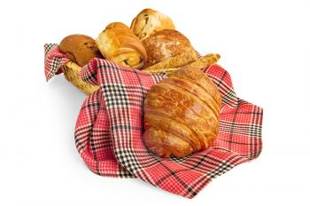 Croissant on a red checkered napkin, buns and bread sticks in a wicker basket isolated on a white background