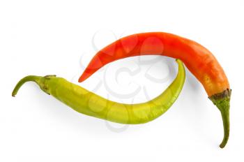 Two sharp green pepper and orange isolated on a white background