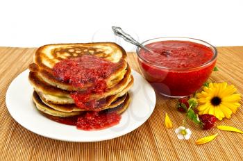 A stack of pancakes on a white plate, strawberry jam in a glass with a spoon, strawberries on a stem with a flower, yellow marigold on a bamboo stand isolated on a white background