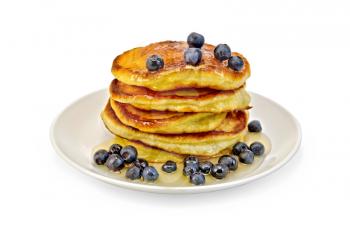 A stack of pancakes with blueberries and honey on a white plate isolated on white background