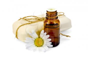 Oil in a bottle, a bar of white soap, tied with twine, daisy flower isolated on white background