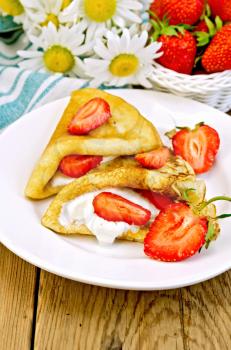 Royalty Free Photo of Crepes and Berries With Cream Beside Daisies