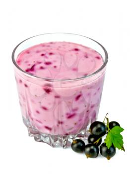 Milkshake in a low glass beaker, berries and green leaves of black currant isolated on white background