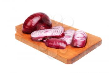 sliced purple onions on cutting board isolated on white 