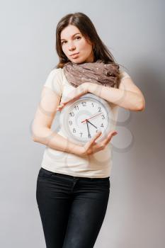 girl holding big clock